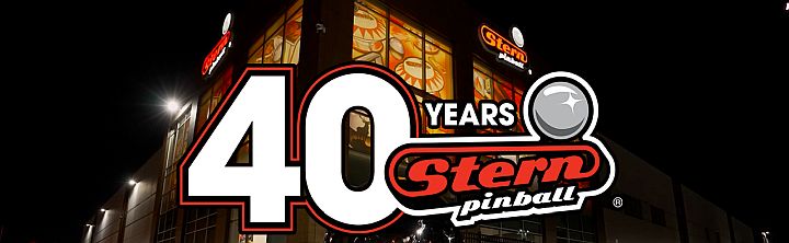 Stern Pinball 40th anniversary banner on a building at night, featuring a large '40 Years' graphic and logo.